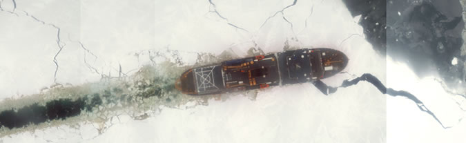 Aerial view mosaic of USCGC Healy cutting through ice.