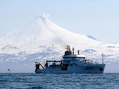 Oscar Dyson with one of the Aleutian volcanos in the background