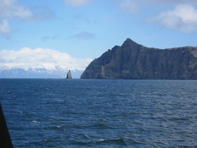 Oscar Dyson with one of the Aleutian volcanos in the background