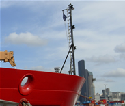 USCGC Healy at the Seattle Coast Guard dock with Seattle skyline as background.