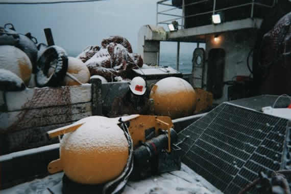 Snow covered buoys on the deck in the Bering Sea
