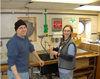 Calvin and Colleen collecting a water sample from the sea chest.
