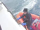 Image of Mark climbing out of a dive boat.