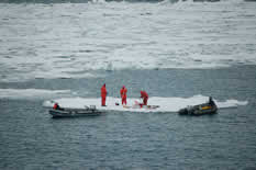Image of 3-person ice coring team on an ice floe.