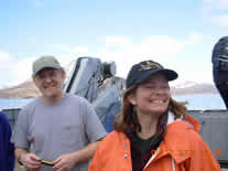 Image of two scientists and Shumagin Islands in the background.