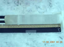 Ice core with meter stick showing ice banding.
