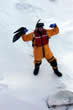 A USCG Diver standing on ice.