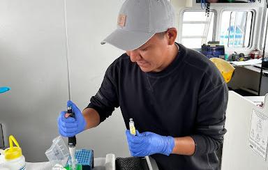 Owen preserving eDNA samples in ethanol on the R/V Storm Petrel 