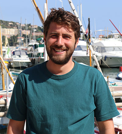 Marin Cornec in front of docked boats