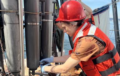 David collecting water samples from a CTD Rosette - a standard collection method in oceanography