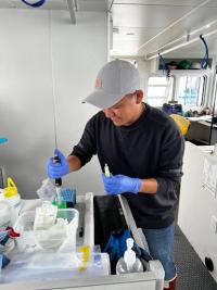 Owen preserving eDNA samples in ethanol on the R/V Storm Petrel 
