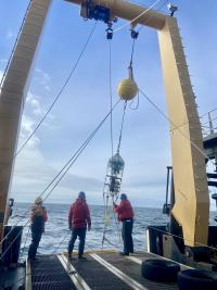 Researchers deploying the automated sampler off the aft deck of the NOAA Oscar Dyson