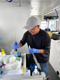 Owen preserving eDNA samples in ethanol on the R/V Storm Petrel