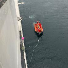 NOAA Oscar Dyson retrieving the OME automated sampler on a small boat