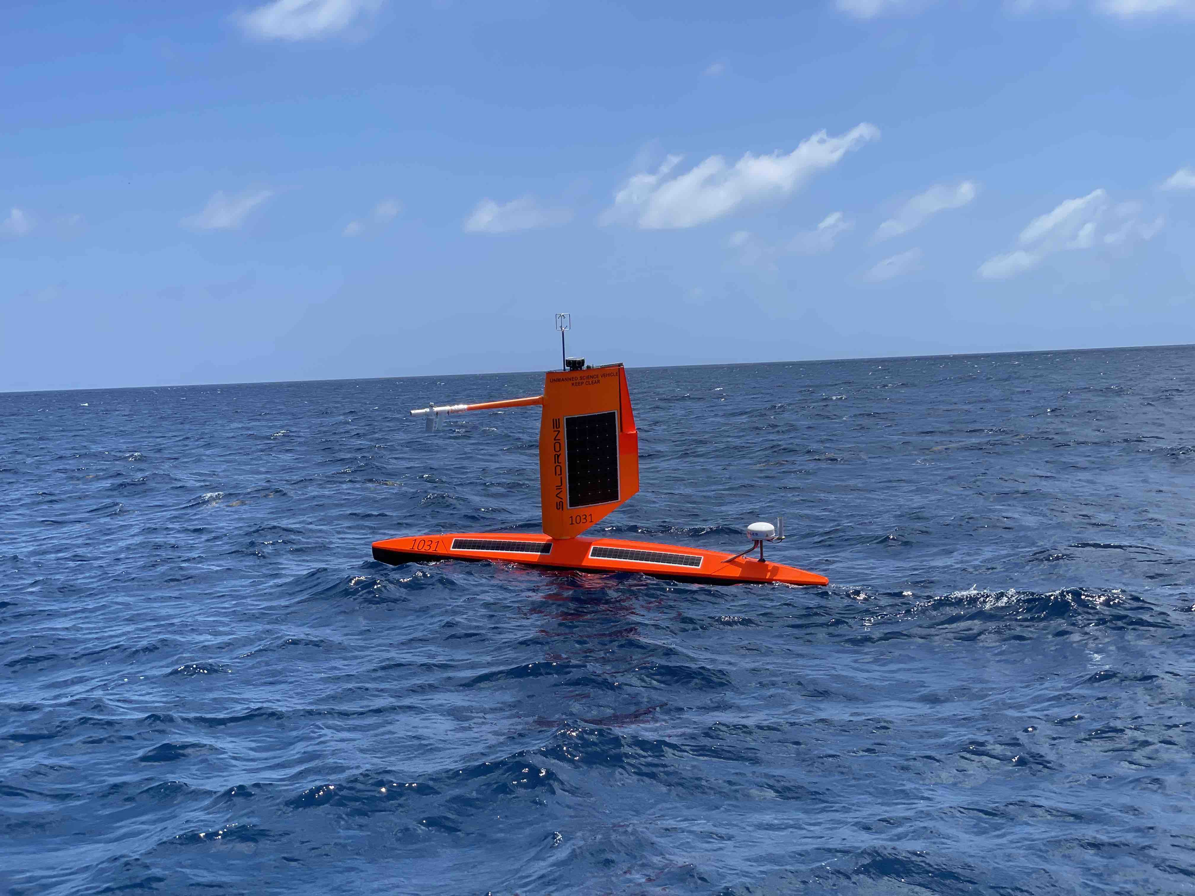 Saildrone SD-1031 floating on open water under blue skies