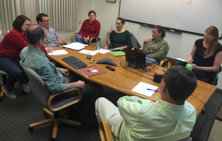 Engineers and scientists sitting together discussing the first phases of the mission.