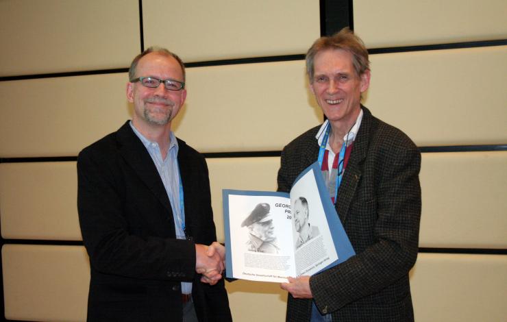 photo of Dr. Greg Johnson receiving the Georg Wust prize