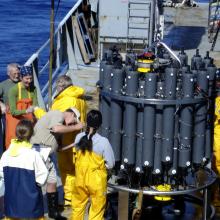 Scientists collecting samples from a CTD (Conductivity-Temperature-Depth) rosette. 