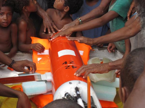 Residents gathering around to touch glider