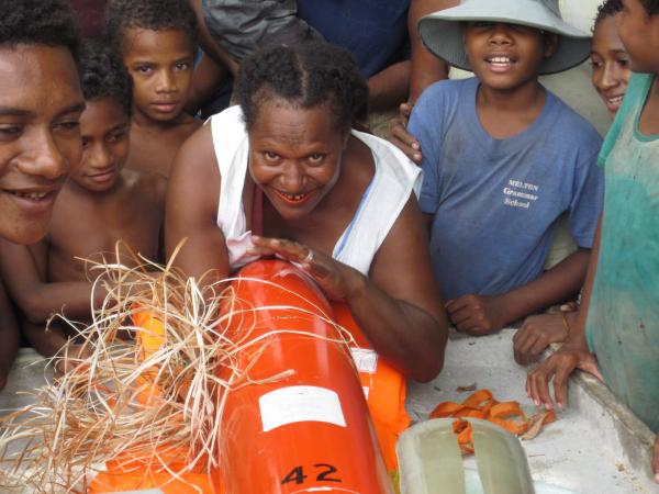 Ponam Island residents gathering around glider