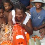 Ponam Island residents gathering around glider