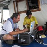Scientist working on laptop aboard ship